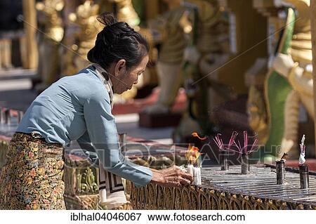 "Local woman lighting candles, sacrificial offerings, Shwedagon Pagoda, Great Dagon Pagoda or Golden Pagoda, Yangon, Myanmar, Asia" View Large Photo Image Stock Photo - "Local woman lighting candles, sacrificial offerings, Shwedagon Pagoda, Great Dagon Pagoda or Golden Pagoda, Yangon, Myanmar, Asia". Fotosearch