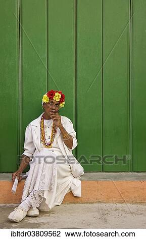 Stock Image - "Local woman posing with a cigar, Havana, Cuba, North America". Fotosearch