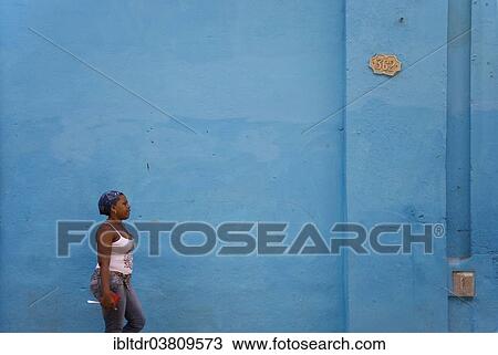 "Local woman walking past a blue wall, Old Havana, Havana, Cuba, North America" View Large Photo Image Stock Image - "Local woman walking past a blue wall, Old Havana, Havana, Cuba, North America". Fotosearch