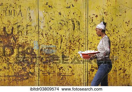 "Local woman walking past a rusty yellow gate, Old Havana, Havana, Cuba, North America" View Large Photo Image Picture - "Local woman walking past a rusty yellow gate, Old Havana, Havana, Cuba, North America". Fotosearch