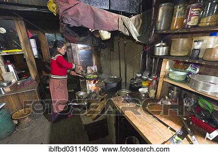 Stock Photography - "Local woman working in a typical Nepali kitchen, Paiya, Solukhumbu District, Sagarmatha Zone, Nepal, Asia". Fotosearch