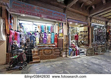 Stock Image - "Local women with prams in the Muttrah Souq market, Muttrah, Muscat, Oman, Asia". Fotosearch