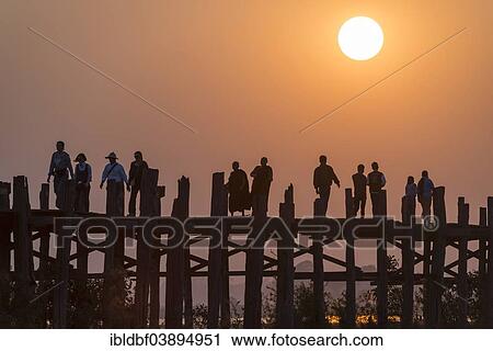 "Locals, monks and tourists walking on a teak bridge, U Bein Bridge across Thaungthaman Lake at sunset, Amarapura, Mandalay Division, Myanmar, Asia" View Large Photo Image Stock Image - "Locals, monks and tourists walking on a teak bridge, U Bein Bridge across Thaungthaman Lake at sunset, Amarapura, Mandalay Division, Myanmar, Asia". Fotosearch