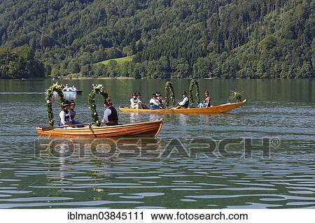 "Locals wearing traditional costumes in decorated wooden Platte boats, Alt-Schlierseer-Kirchtag festival, Schliersee, Upper Bavaria, Bavaria, Germany, Europe" View Large Photo Image Stock Image - "Locals wearing traditional costumes in decorated wooden Platte boats, Alt-Schlierseer-Kirchtag festival, Schliersee, Upper Bavaria, Bavaria, Germany, Europe". Fotosearch