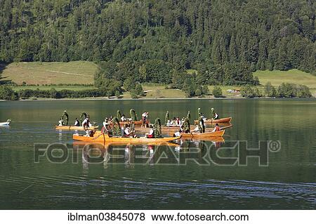 Stock Photo - "Locals wearing traditional costumes in decorated wooden Platte boats, Alt-Schlierseer-Kirchtag festival, Schliersee, Upper Bavaria, Bavaria, Germany, Europe". Fotosearch