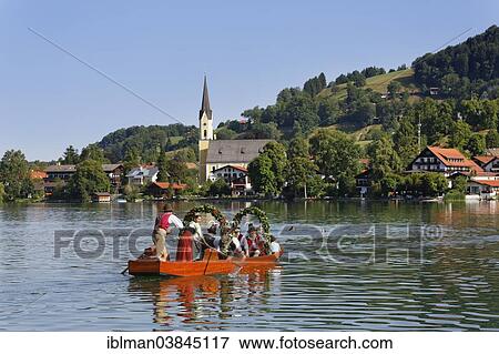 "Locals wearing traditional costumes in decorated wooden Platte boats, the church of St. Sixtus at the back, Alt-Schlierseer-Kirchtag festival, Schliersee, Upper Bavaria, Bavaria, Germany, Europe" View Large Photo Image Stock Photo - "Locals wearing traditional costumes in decorated wooden Platte boats, the church of St. Sixtus at the back, Alt-Schlierseer-Kirchtag festival, Schliersee, Upper Bavaria, Bavaria, Germany, Europe". Fotosearch