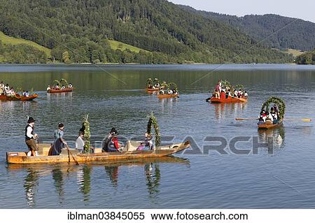 "Locals wearing traditional costumes in decorated wooden Platte boats, Alt-Schlierseer-Kirchtag festival, Schliersee, Upper Bavaria, Bavaria, Germany, Europe" View Large Photo Image Stock Photography - "Locals wearing traditional costumes in decorated wooden Platte boats, Alt-Schlierseer-Kirchtag festival, Schliersee, Upper Bavaria, Bavaria, Germany, Europe". Fotosearch