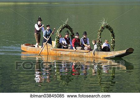 "Locals wearing traditional costumes in a decorated wooden Platte boat, Alt-Schlierseer-Kirchtag festival, Schliersee, Upper Bavaria, Bavaria, Germany, Europe" View Large Photo Image Stock Photography - "Locals wearing traditional costumes in a decorated wooden Platte boat, Alt-Schlierseer-Kirchtag festival, Schliersee, Upper Bavaria, Bavaria, Germany, Europe". Fotosearch