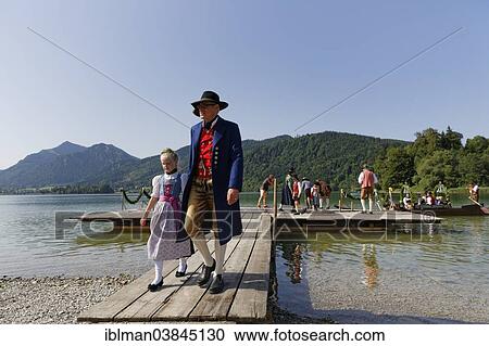 "Locals wearing traditional costumes disembarking a boat at a jetty, Alt-Schlierseer-Kirchtag festival, Schliersee, Upper Bavaria, Bavaria, Germany, Europe" View Large Photo Image Stock Image - "Locals wearing traditional costumes disembarking a boat at a jetty, Alt-Schlierseer-Kirchtag festival, Schliersee, Upper Bavaria, Bavaria, Germany, Europe". Fotosearch