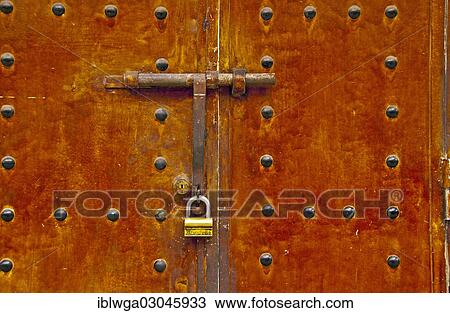 Stock Image - "Lock and bar on an old metal door, Morocco, Africa". Fotosearch