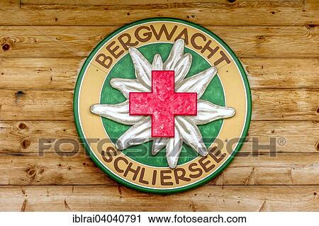Stock Image - "Logo of the Schliersee mountain rescue service, on a wooden hut, Spitzingsee, near Schliersee, Upper Bavaria, Bavaria, Germany, Europe". Fotosearch