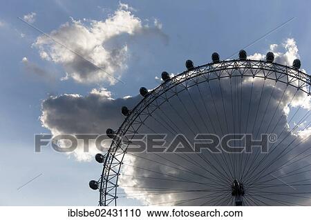 Stock Image - "London Eye ferris wheel with clouds, London, England, United Kingdom, Europe". Fotosearch
