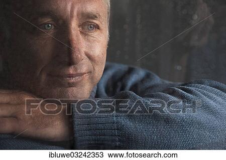 "Lonely man sitting behind a window covered in rain drops, Mannheim, Baden-Wurttemberg, Germany, Europe" View Large Photo Image Stock Image - "Lonely man sitting behind a window covered in rain drops, Mannheim, Baden-Wurttemberg, Germany, Europe". Fotosearch