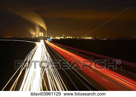 "Long exposure at night, light trails on the A38 motorway, Schkopau power plant at the back, Saxony-Anhalt, Germany, Europe" View Large Photo Image Stock Photo - "Long exposure at night, light trails on the A38 motorway, Schkopau power plant at the back, Saxony-Anhalt, Germany, Europe". Fotosearch