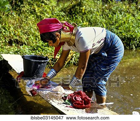 "Long-necked woman of the Padaung mountain tribe, also known as giraffe women, wearing neck rings and washing laundry, Chiang Rai Province, Northern Thailand, Thailand, Asia" View Large Photo Image Stock Photo - "Long-necked woman of the Padaung mountain tribe, also known as giraffe women, wearing neck rings and washing laundry, Chiang Rai Province, Northern Thailand, Thailand, Asia". Fotosearch