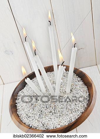 Long-stemmed candles in a wooden bowl View Large Photo Image Stock Image - Long-stemmed candles in a wooden bowl. Fotosearch