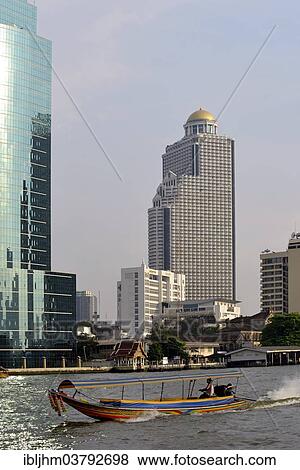 "Long-tail boat on the Chao Phraya River with the State Tower at back, Bangkok, Thailand, Asia" View Large Photo Image Stock Photo - "Long-tail boat on the Chao Phraya River with the State Tower at back, Bangkok, Thailand, Asia". Fotosearch