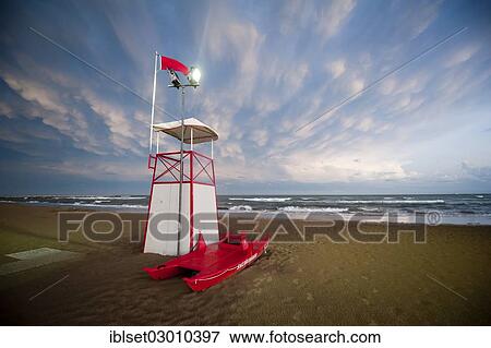 "Lookout tower and a rowing boat, atmospheric clouds in the evening by the sea, Cavallino, Jesolo, Venedig, Italy, Europe" View Large Photo Image Stock Photo - "Lookout tower and a rowing boat, atmospheric clouds in the evening by the sea, Cavallino, Jesolo, Venedig, Italy, Europe". Fotosearch