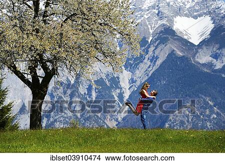 "Lovers embracing next to a flowering tree, in the spring, mountains at the back, Tyrol, Austria, Europe" View Large Photo Image Picture - "Lovers embracing next to a flowering tree, in the spring, mountains at the back, Tyrol, Austria, Europe". Fotosearch
