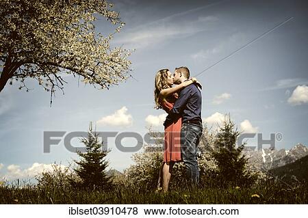 "Lovers kissing next to a flowering tree in the spring, Tyrol, Austria, Europe" View Large Photo Image Stock Photo - "Lovers kissing next to a flowering tree in the spring, Tyrol, Austria, Europe". Fotosearch
