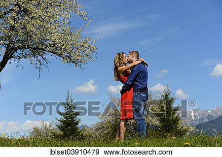 "Lovers kissing next to a flowering tree in the spring, Tyrol, Austria, Europe" View Large Photo Image Stock Photo - "Lovers kissing next to a flowering tree in the spring, Tyrol, Austria, Europe". Fotosearch