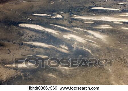 "Low coastal dunes and barren desert land in the Namib Desert, aerial view, Namib-Skeleton Coast National Park, near Walvis Bay, Namibia, Africa" View Large Photo Image Stock Photo - "Low coastal dunes and barren desert land in the Namib Desert, aerial view, Namib-Skeleton Coast National Park, near Walvis Bay, Namibia, Africa". Fotosearch