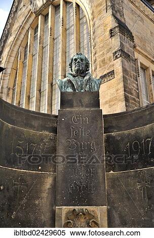 Stock Photography - "Luther monument with the inscription """"Ein feste Burg ist unser Gott"""", German for """"A Mighty Fortress is Our God"""", in front of St. Mary's Cathedral in Freiberg, Erzgebirge, Ore Mountains, Saxony, Germany, Europe". Fotosearch