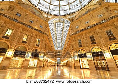 Stock Image - "Luxury shopping arcade, roofed gallery of Galleria Vittorio Emanuele II, twilight shot at the blue hour, Milan, Lombardy, Italy, Europe". Fotosearch
