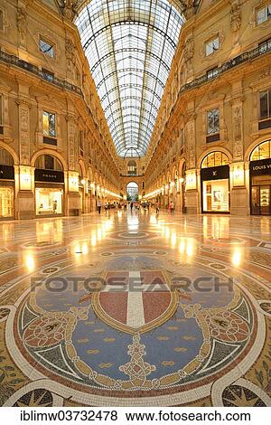 "Luxury shopping arcade, roofed gallery of Galleria Vittorio Emanuele II, twilight shot at the blue hour, marble floor mosaic with the coat of arms of Milan, Milan, Lombardy, Italy, Europe" View Large Photo Image Stock Photo - "Luxury shopping arcade, roofed gallery of Galleria Vittorio Emanuele II, twilight shot at the blue hour, marble floor mosaic with the coat of arms of Milan, Milan, Lombardy, Italy, Europe". Fotosearch