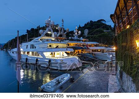 Stock Photography - "Luxury yachts in the harbor at dusk, Portofino, Italian Riviera, Gulf of Genoa, Liguria, Italy, Europe". Fotosearch