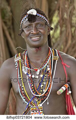 Picture - "Maasai warrior wearing traditional dress, near Enkutoto, Masai Mara, Rift Valley Province, Kenya, Africa". Fotosearch