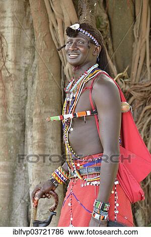 "Maasai warrior wearing traditional dress, near Enkutoto, Masai Mara, Rift Valley Province, Kenya, Africa" View Large Photo Image Stock Photograph - "Maasai warrior wearing traditional dress, near Enkutoto, Masai Mara, Rift Valley Province, Kenya, Africa". Fotosearch