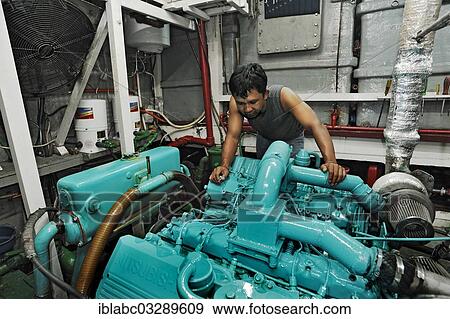 "Machine operator in the engine room on the Buginese Schooner, Seven Seas Liveaboard, Dampier Strait, West Papua, Indonesia, Asia" View Large Photo Image Stock Photo - "Machine operator in the engine room on the Buginese Schooner, Seven Seas Liveaboard, Dampier Strait, West Papua, Indonesia, Asia". Fotosearch