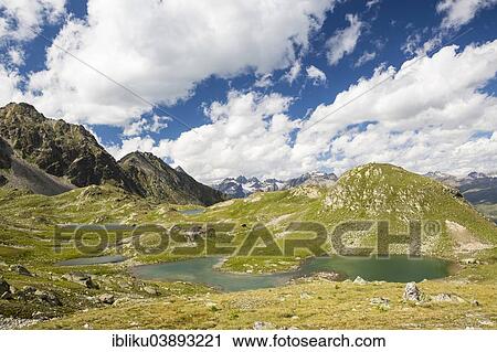 Stock Image - "Macun lake plateau, views to the Verstancla group and Silvretta group, Swiss National Park, Graubunden, Switzerland, Europe". Fotosearch