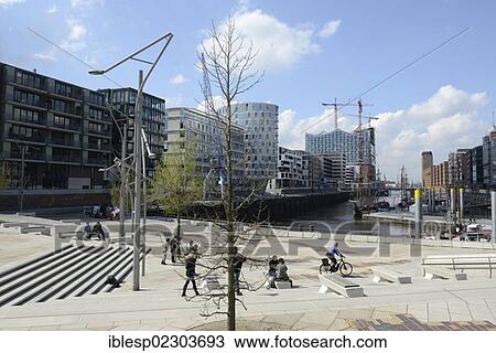 "Magellan Terraces, modern residential and office buildings, Elbe Philharmonic Hall under construction at back, Sandtorhafen harbour, Sandtorkai and Kaiserkai streets, HafenCity, Hamburg, Hamburg, Germany, Europe" View Large Photo Image Stock Image - "Magellan Terraces, modern residential and office buildings, Elbe Philharmonic Hall under construction at back, Sandtorhafen harbour, Sandtorkai and Kaiserkai streets, HafenCity, Hamburg, Hamburg, Germany, Europe". Fotosearch