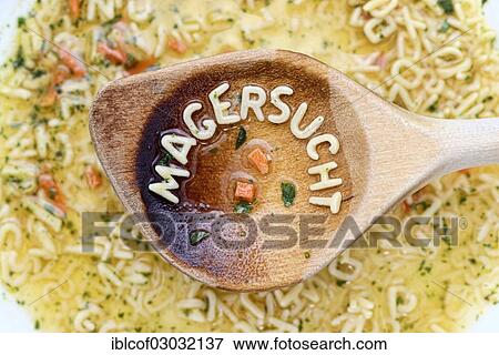 Stock Photo - "Magersucht"""", German for """"anorexia"""", written with pasta letters on a wooden spoon, Germany, Europe". Fotosearch