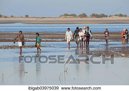 Stock Photo - "Malagasy people crossing the water, Morondava, Toliara province, Madagascar, Africa". Fotosearch