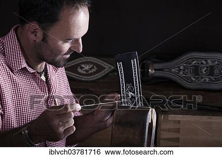 Stock Photograph - "Male, 35-40 years, doing pinfeather embroidery, Reith im Alpbach, Tyrol, Austria, Europe". Fotosearch
