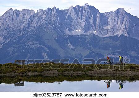 "Male and female mountain bikers passing a reservoir, Ehrenbachhohe, Kirchberg, Tyrol, Austria, Europe" View Large Photo Image Stock Photo - "Male and female mountain bikers passing a reservoir, Ehrenbachhohe, Kirchberg, Tyrol, Austria, Europe". Fotosearch