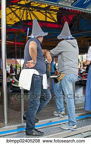 Stock Photo - "Male Oktoberfest visitors, Oktoberfest, Munich, Bavaria, Germany, Europe". Fotosearch