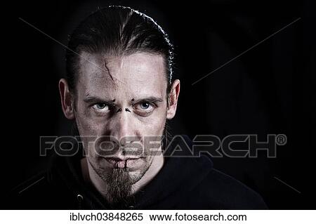 "Man, 30-35, with a scar on his forehead, piercings and long black hair" View Large Photo Image Stock Photography - "Man, 30-35, with a scar on his forehead, piercings and long black hair". Fotosearch