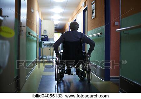 Stock Image - "Man, 78 years, in a wheelchair, corridor, nursing home". Fotosearch