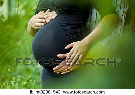 Man and a pregnant woman holding their hands on her belly View Large Photo Image Stock Image - Man and a pregnant woman holding their hands on her belly. Fotosearch
