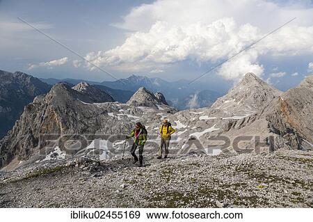 "Man and a woman hiking on Kredarica Mountain, Triglav National Park, Slovenia, Europe" View Large Photo Image Stock Photo - "Man and a woman hiking on Kredarica Mountain, Triglav National Park, Slovenia, Europe". Fotosearch