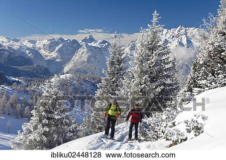 "Man and a woman snowshoeing in Berchtesgaden National Park, snowshoe route to Torrener Joch pass, Watzmann Mountain and Hundstod Mountain at the rear, Berchtesgadener Land, Bavaria, Germany, Europe" View Large Photo Image Stock Photo - "Man and a woman snowshoeing in Berchtesgaden National Park, snowshoe route to Torrener Joch pass, Watzmann Mountain and Hundstod Mountain at the rear, Berchtesgadener Land, Bavaria, Germany, Europe". Fotosearch