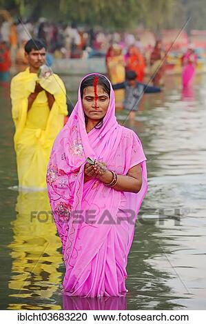"Man and a woman wearing a sari standing in water during the Hindu Chhath Festival, New Delhi, Delhi, India, Asia" View Large Photo Image Stock Image - "Man and a woman wearing a sari standing in water during the Hindu Chhath Festival, New Delhi, Delhi, India, Asia". Fotosearch