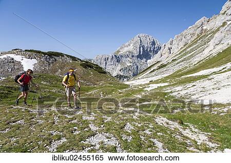 "Man and a woman while hiking, climbing from Vodnikov dom refuge to Triglav, Triglav National Park, Slovenia, Europe" View Large Photo Image Stock Photography - "Man and a woman while hiking, climbing from Vodnikov dom refuge to Triglav, Triglav National Park, Slovenia, Europe". Fotosearch