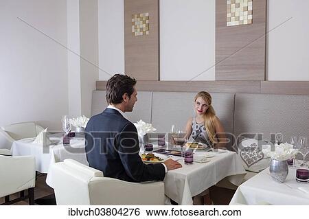 Man and woman having dinner in a restaurant View Large Photo Image Stock Photograph - Man and woman having dinner in a restaurant. Fotosearch