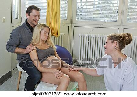 Stock Photo - "Man and woman in the delivery room during childbirth, the woman is leaning exhausted against her husband during a pause between contractions, Germany, Europe". Fotosearch