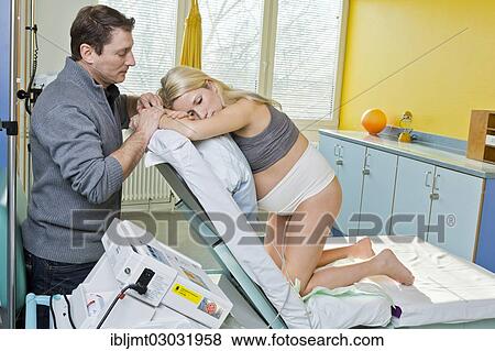 "Man and woman in the delivery room during childbirth, the woman kneeling on the delivery bed and resting, she is connected to a cardiotocography or CTG, Germany, Europe" View Large Photo Image Stock Photo - "Man and woman in the delivery room during childbirth, the woman kneeling on the delivery bed and resting, she is connected to a cardiotocography or CTG, Germany, Europe". Fotosearch